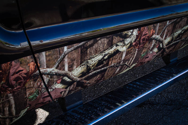 Mossy Oak camouflage wrap on the rocker panels of a Ford F-250. Close up view.