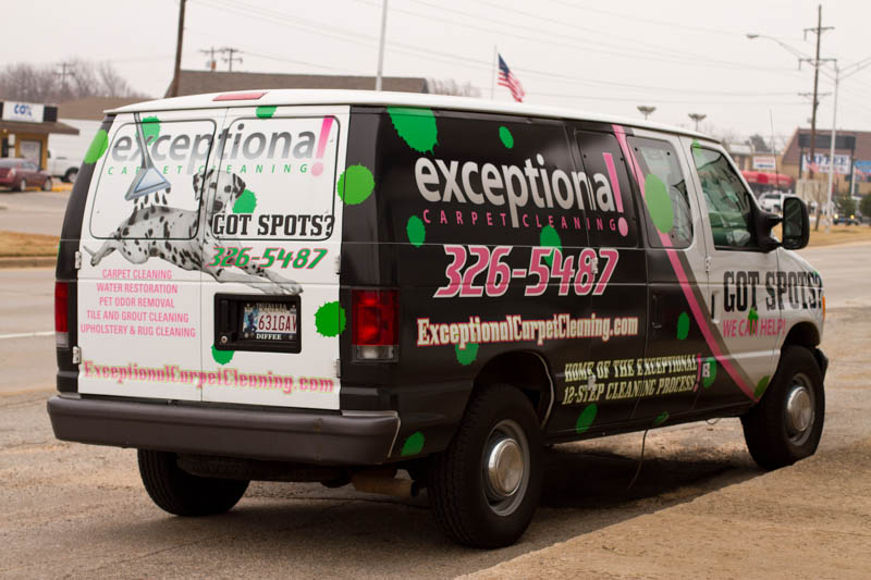 A black and white van wrap with colored paint drops for Exceptional Carpet Cleaning