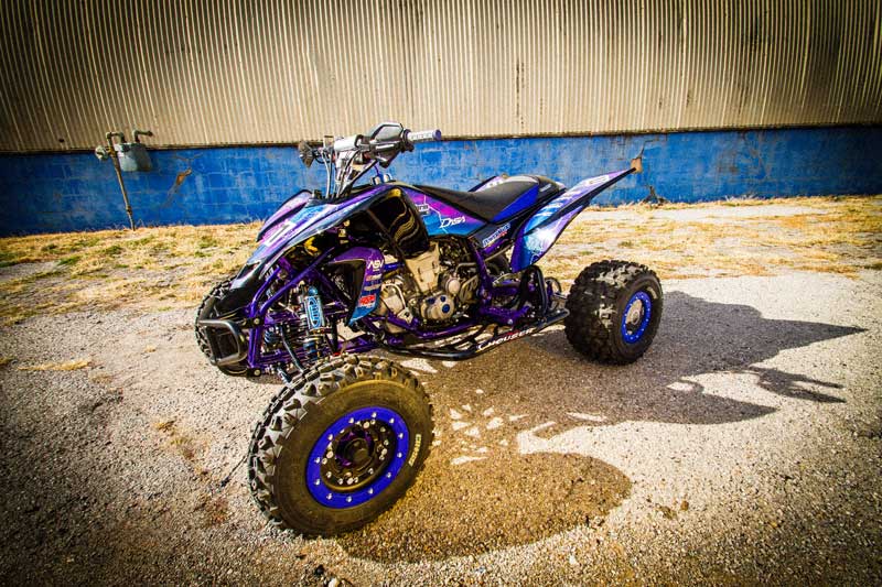 A quad racer with custom vehicle wrap graphics.
