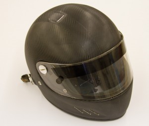 A racing helmet that has been wrapped in 3M 1080 dinoc carbon fiber wrap material